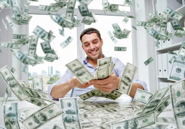 happy businessman with heap of money